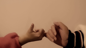 实拍与孩子拉钩握手温馨亲切画面